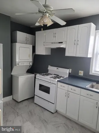 a kitchen with cabinets appliances and a fireplace