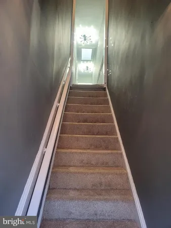 a view of a hallway with wooden floor and entryway