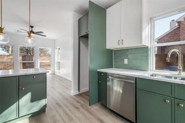 a kitchen with a sink cabinets and window