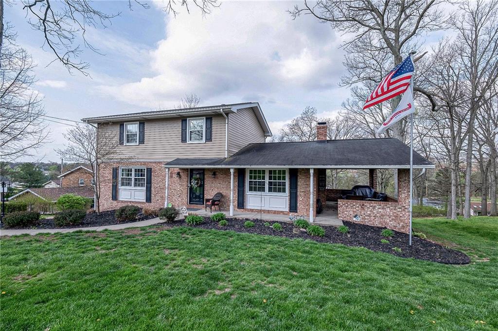 114 Truman Street Monaca, PA 15061 - Photo 1 of 30 a front view of a house with a garden and trees
