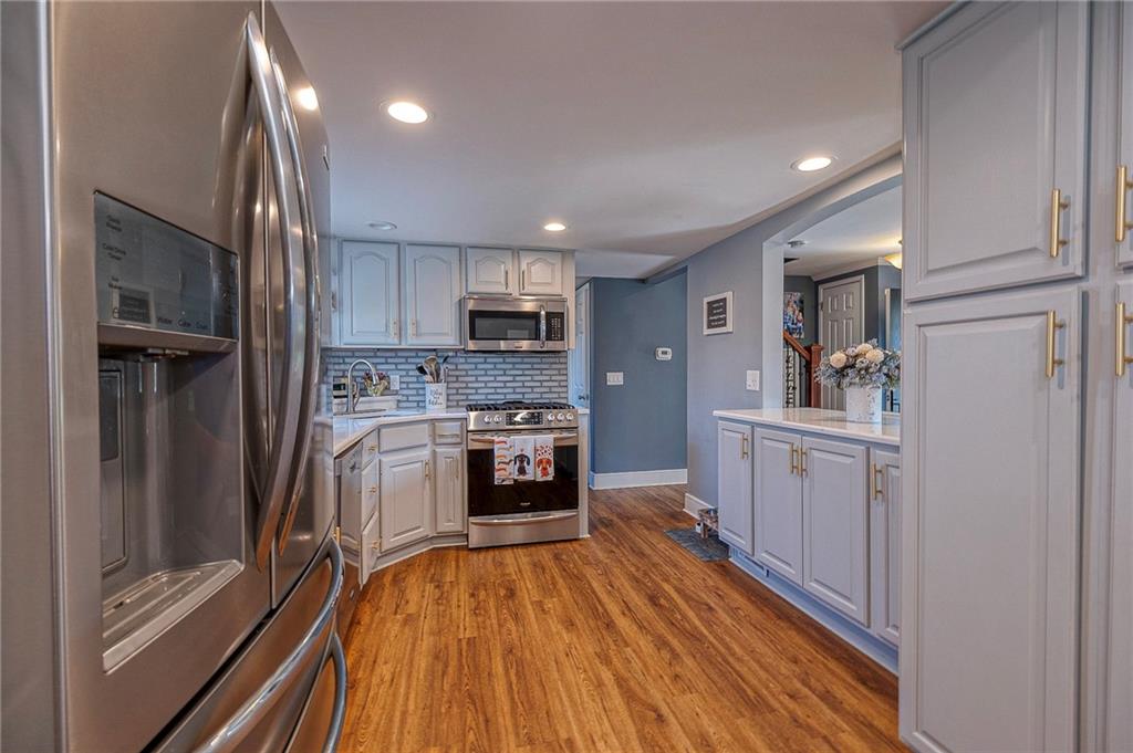114 Truman Street Monaca, PA 15061 - Photo 12 of 30 a kitchen with a refrigerator a stove top oven and a sink
