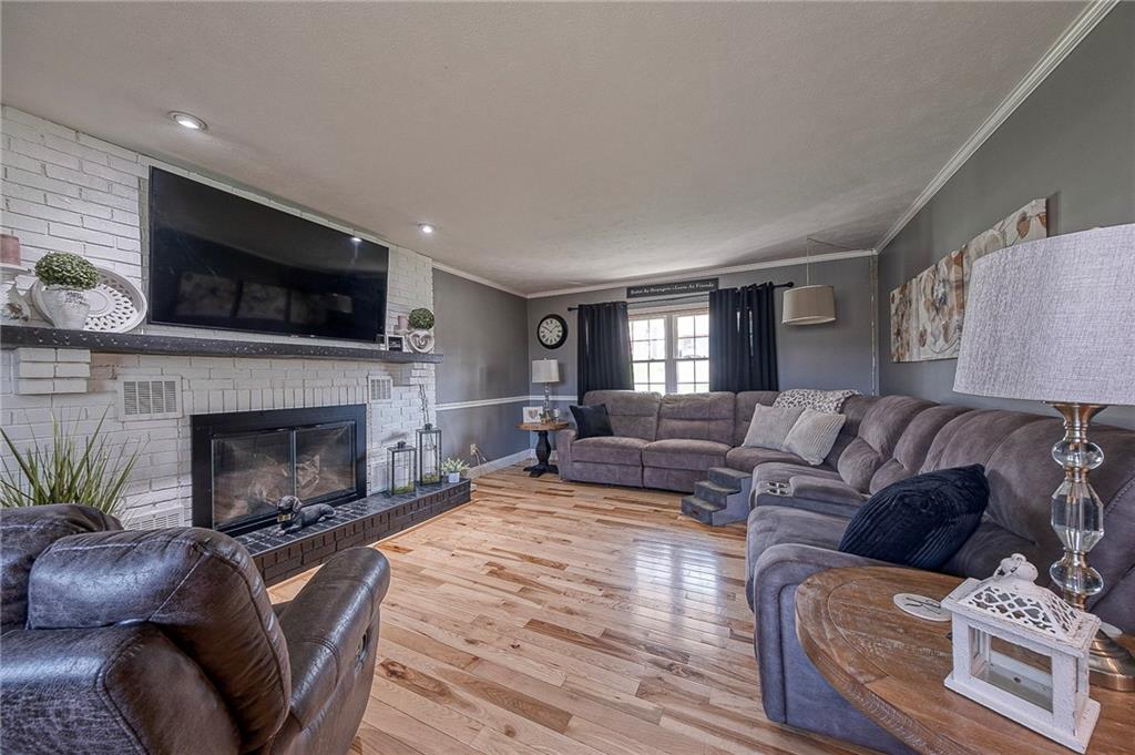 114 Truman Street Monaca, PA 15061 - Photo 15 of 30 a living room with furniture a flat screen tv and a fireplace