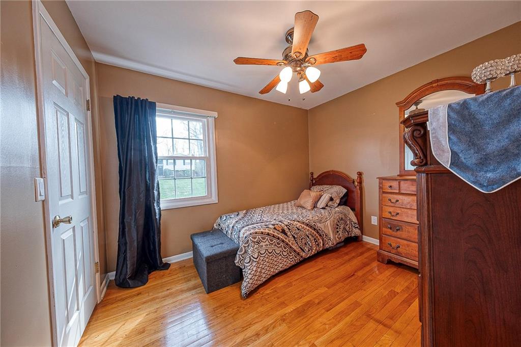 114 Truman Street Monaca, PA 15061 - Photo 24 of 30 a bedroom with a bed and a chandelier