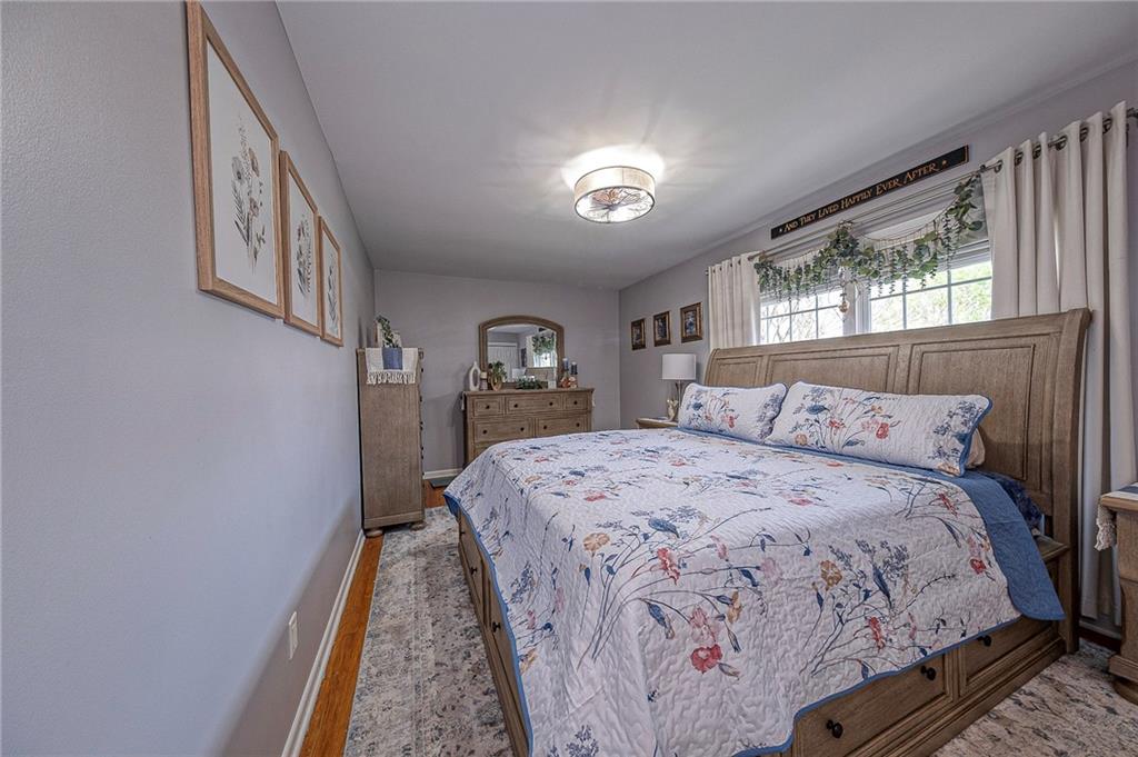 114 Truman Street Monaca, PA 15061 - Photo 25 of 30 a bedroom with a large bed and a chandelier