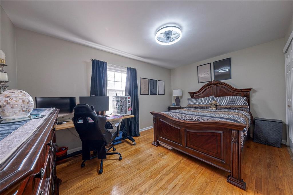 114 Truman Street Monaca, PA 15061 - Photo 26 of 30 a bedroom with a bed and wooden floor
