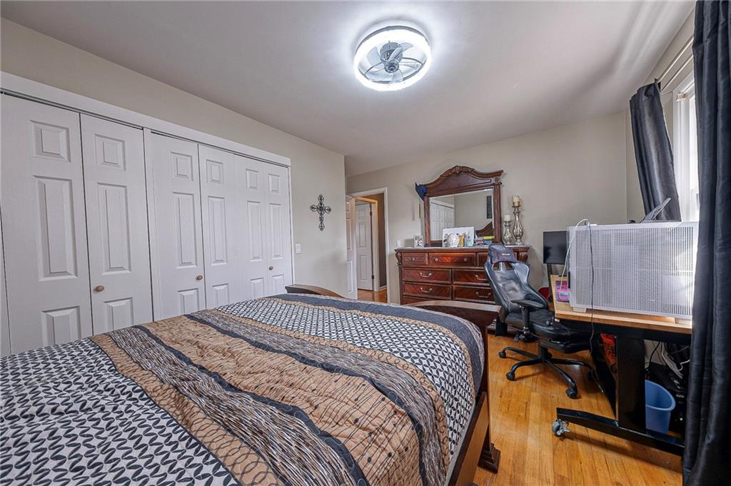 114 Truman Street Monaca, PA 15061 - Photo 27 of 30 a bedroom with a bed and a chandelier