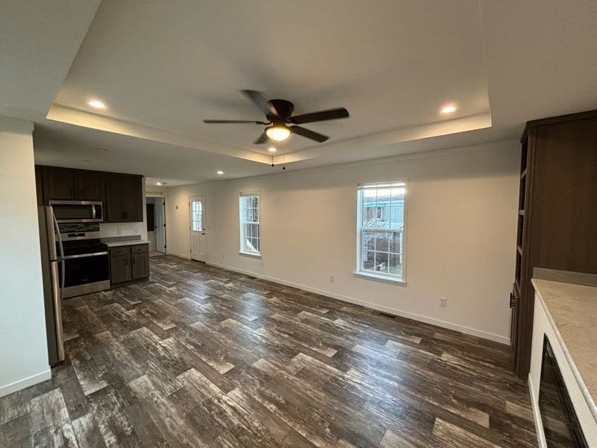 557 Southwest Cutoff, Unit 90 Worcester, MA 01607 - Photo 3 of 12 a view of kitchen and empty room with wooden floor