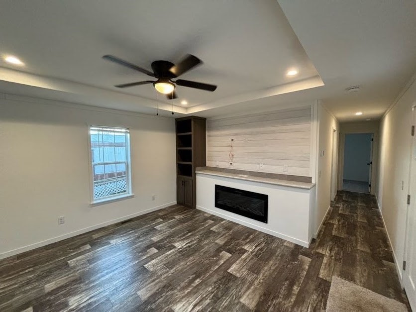 557 Southwest Cutoff, Unit 90 Worcester, MA 01607 - Photo 4 of 12 a view of empty room with wooden floor and fan