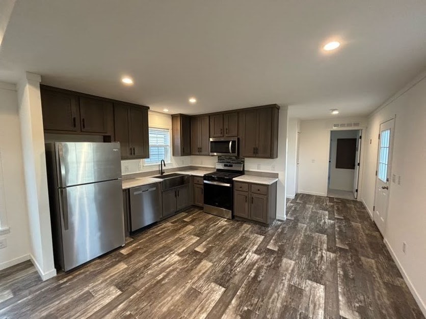 557 Southwest Cutoff, Unit 90 Worcester, MA 01607 - Photo 5 of 12 a kitchen with a refrigerator a sink and a microwave