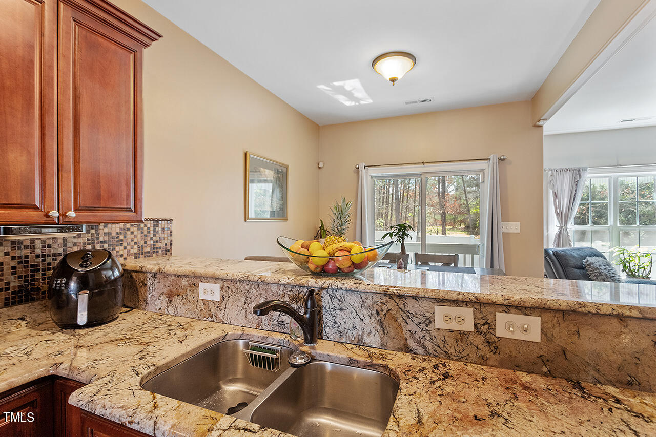 4628 Pat Reed Road Raleigh, NC 27616 - Photo 13 of 34 a kitchen with a sink and a stove top oven