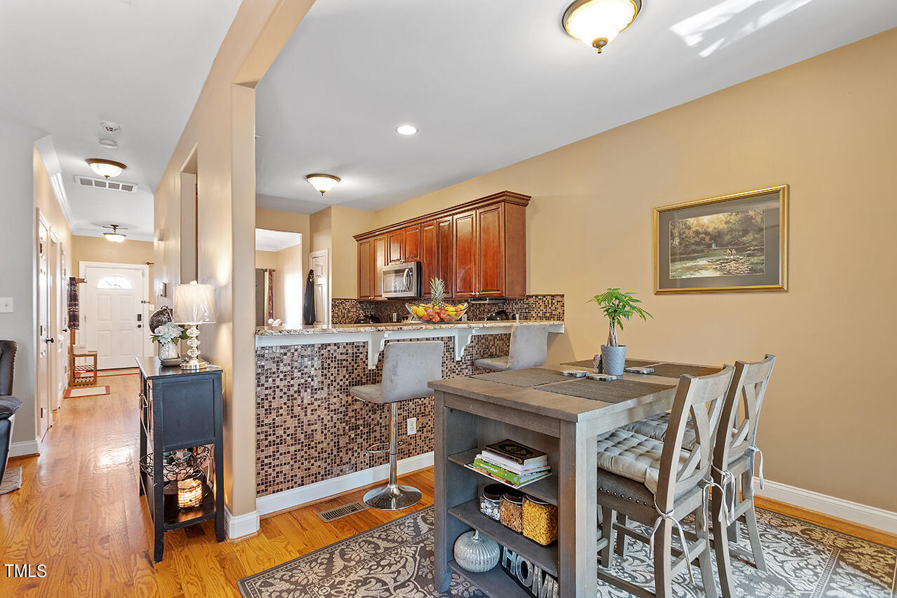 4628 Pat Reed Road Raleigh, NC 27616 - Photo 15 of 34 a view of a dining room with furniture and wooden floor