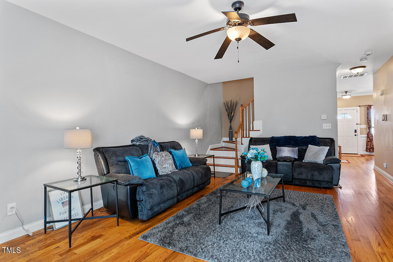 4628 Pat Reed Road Raleigh, NC 27616 - Photo 16 of 34 a living room with furniture a rug and a chandelier