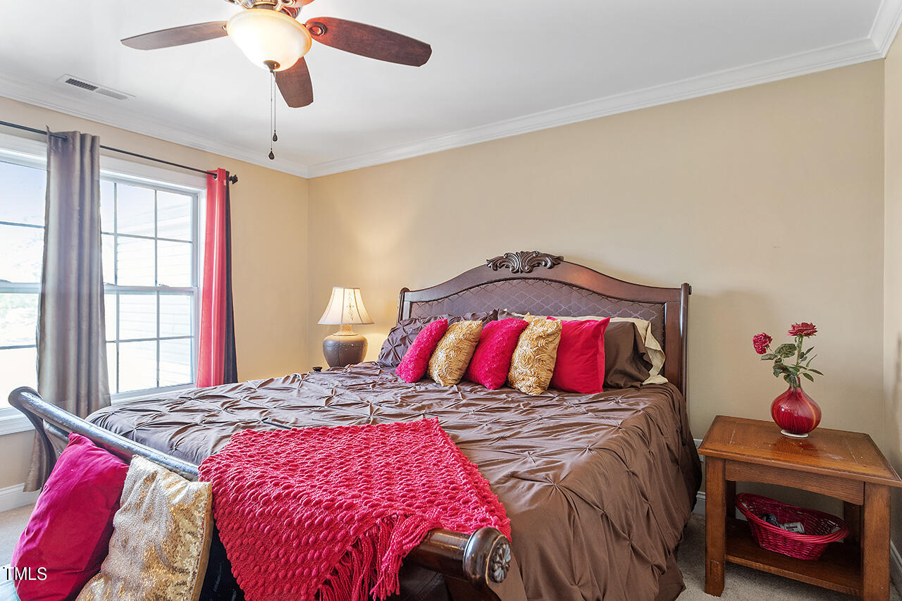 4628 Pat Reed Road Raleigh, NC 27616 - Photo 19 of 34 a bedroom with a bed and a couch