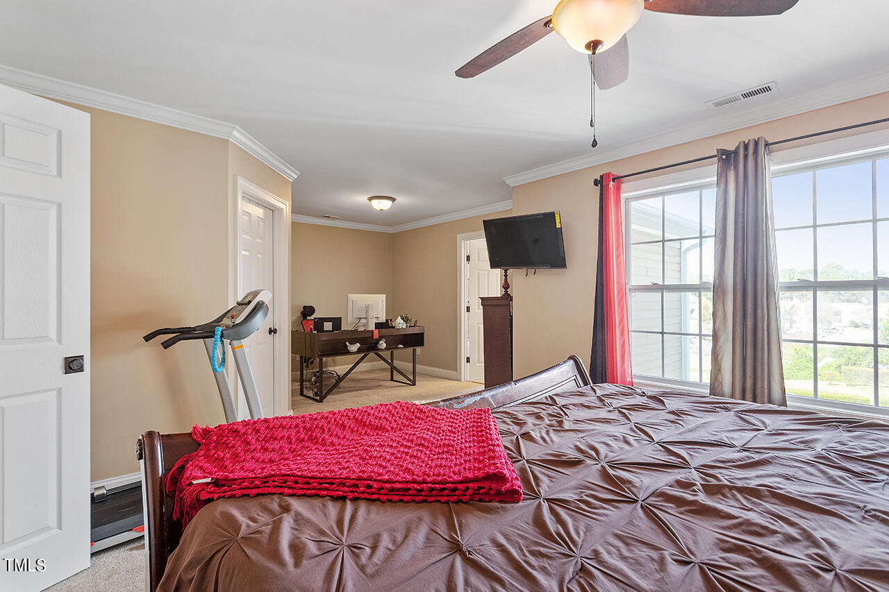 4628 Pat Reed Road Raleigh, NC 27616 - Photo 20 of 34 a bedroom with a bed and a large window