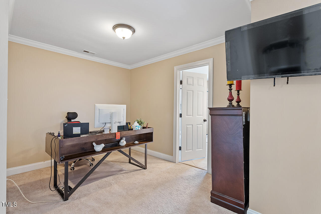 4628 Pat Reed Road Raleigh, NC 27616 - Photo 23 of 34 a living room with furniture and a flat screen tv