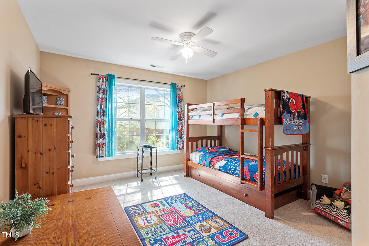 4628 Pat Reed Road Raleigh, NC 27616 - Photo 30 of 34 a bedroom with furniture and a rug