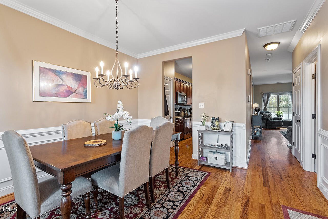 4628 Pat Reed Road Raleigh, NC 27616 - Photo 4 of 34 a view of a dining room with furniture and wooden floor