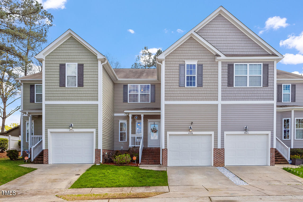 4628 Pat Reed Road Raleigh, NC 27616 - Photo 5 of 34 a front view of a house with a yard and garage