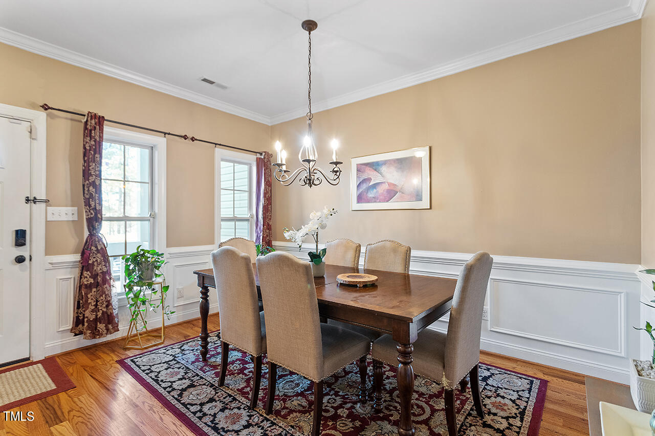 4628 Pat Reed Road Raleigh, NC 27616 - Photo 7 of 34 a view of a dining room with furniture window and wooden floor