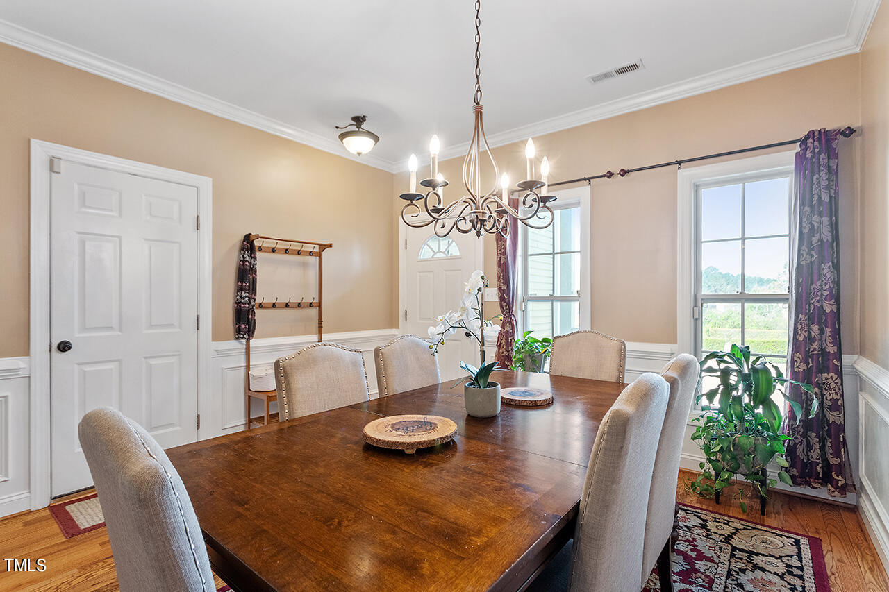 4628 Pat Reed Road Raleigh, NC 27616 - Photo 8 of 34 a view of a dining room with furniture window and wooden floor