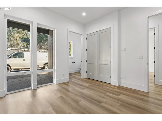 a view of empty room with wooden floor