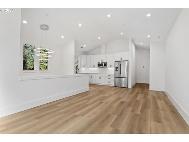 a view of a kitchen with an empty space and a window