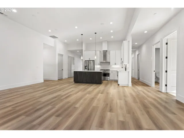 a kitchen with a sink cabinets and wooden floor