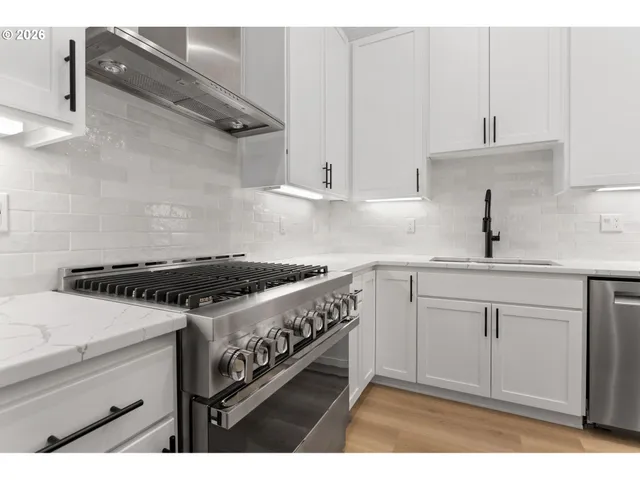 a kitchen with a sink stove and cabinets