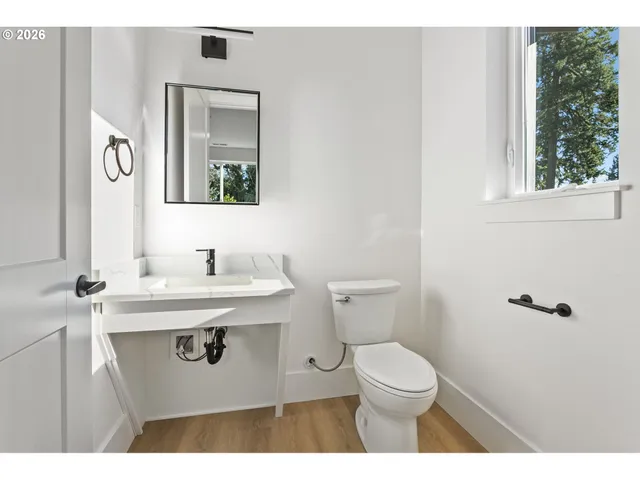 a bathroom with a sink a toilet and mirror