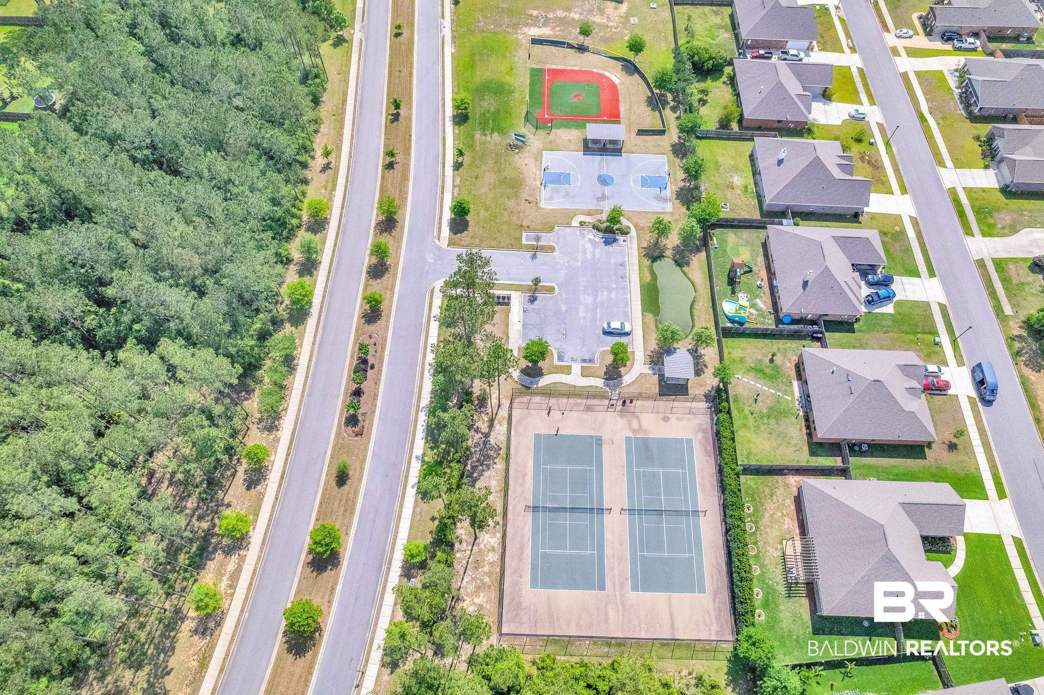 13233 Ibis Boulevard Daphne, AL 36527 - Photo 99 of 100 Community amenities featuring tennis courts, basketball courts, a baseball field, and a parking area with a small pond