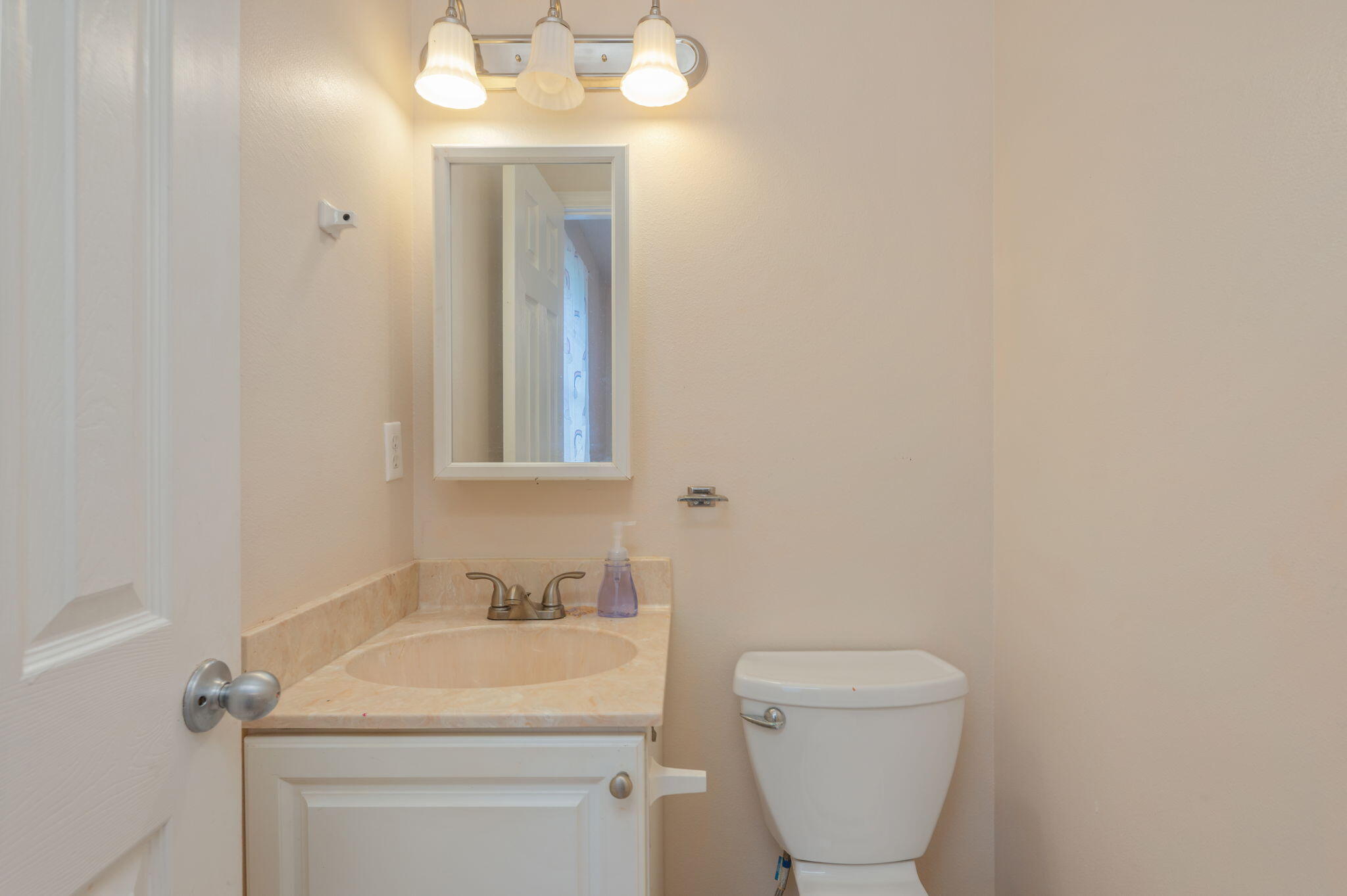 834 McDonald Street Crestview, FL 32536 - Photo 16 of 35 a bathroom with a toilet sink and mirror