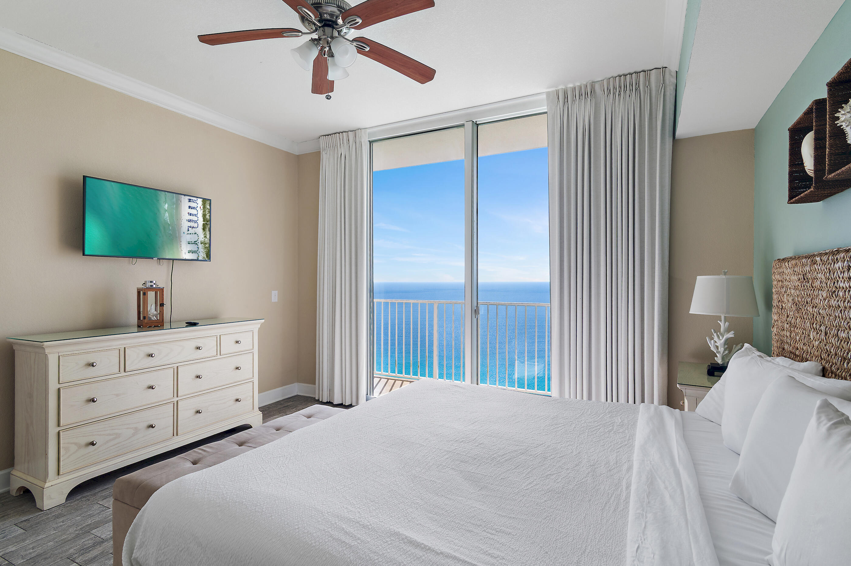 16819 Front Beach Road, Unit 2612 Panama City Beach, FL 32413 - Photo 19 of 53 a bedroom with a bed and a chandelier