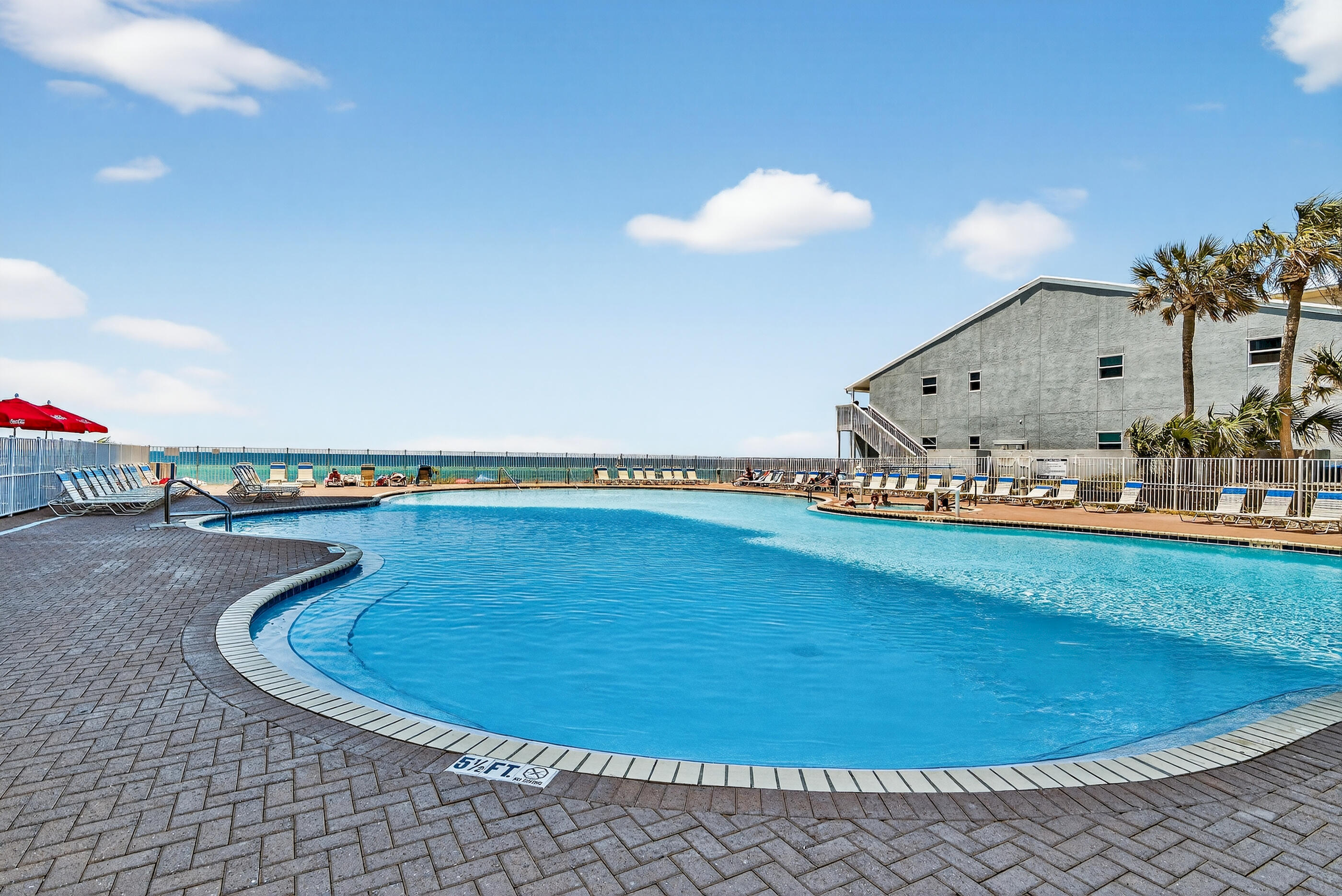 16819 Front Beach Road, Unit 2612 Panama City Beach, FL 32413 - Photo 25 of 53 a view of a swimming pool with a yard and plants