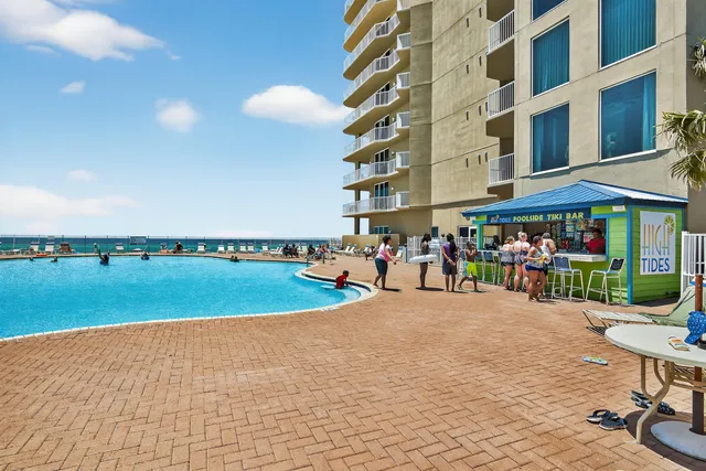 a view of a swimming pool with chairs in patio