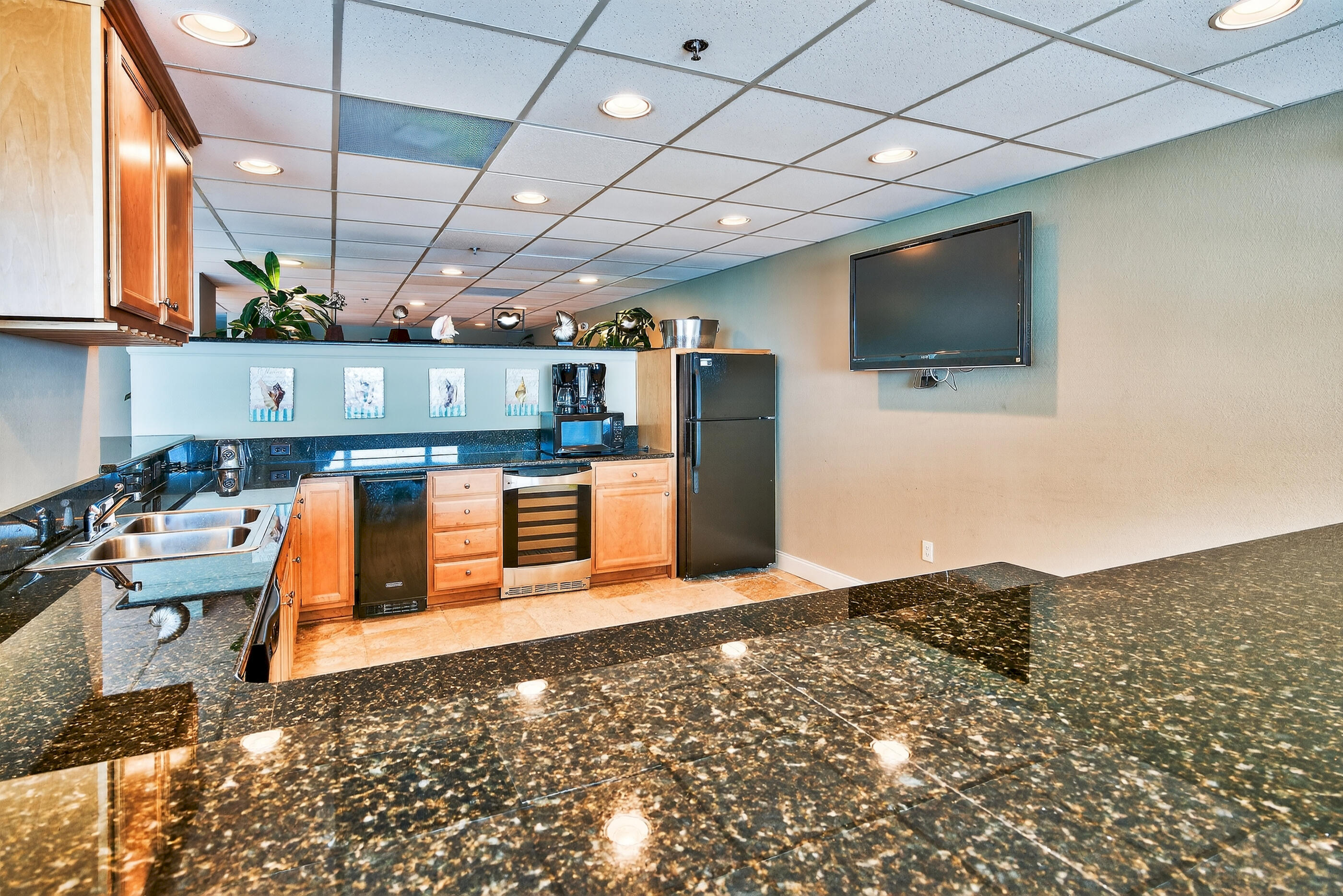 16819 Front Beach Road, Unit 2612 Panama City Beach, FL 32413 - Photo 33 of 53 a kitchen with stainless steel appliances kitchen island granite countertop a stove and a sink with cabinets