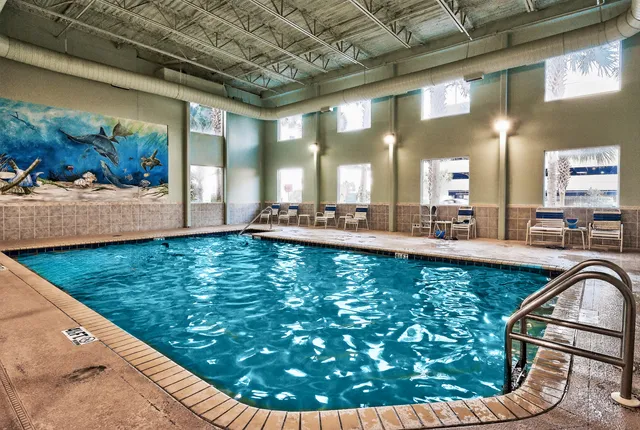 a view of a swimming pool with outdoor seating