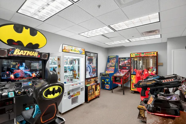 a view of a dining hall with furniture and a large window