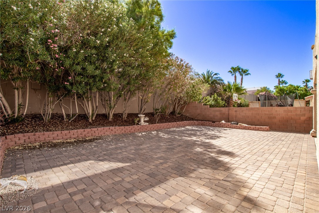 1477 Rancho Ridge Drive Henderson, NV 89012 - Photo 43 of 46 A spacious, paver-lined yard offers an ideal setting for outdoor enjoyment.