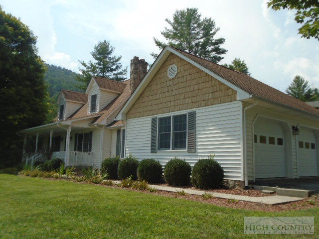 a view of a house with a yard and plants