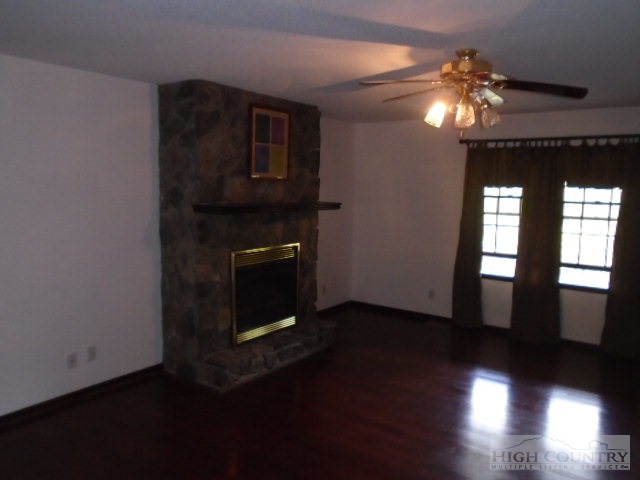 717 A Deep Ford Road Lansing, NC 28643 - Photo 14 of 18 a living room with hard wood floors and a fireplace
