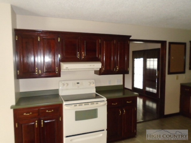 717 A Deep Ford Road Lansing, NC 28643 - Photo 9 of 18 a kitchen with a stove and a refrigerator