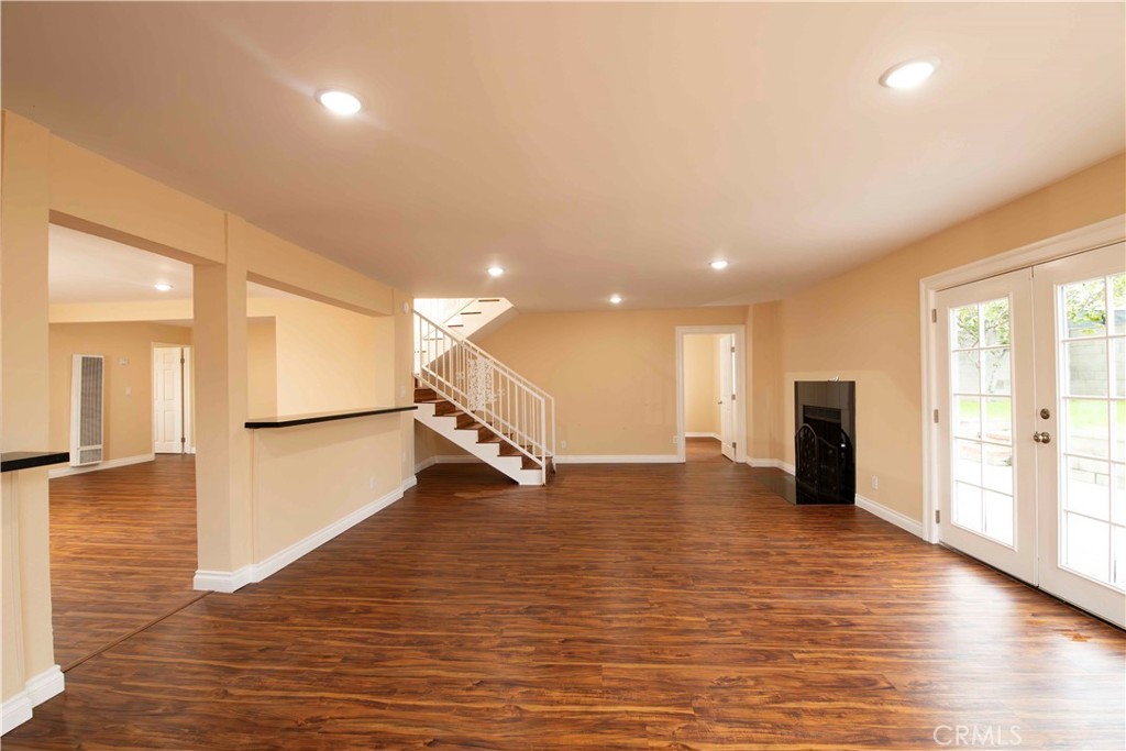 143 West 234th Place Carson, CA 90745 - Photo 13 of 46 a view of an empty room with wooden floor and a window