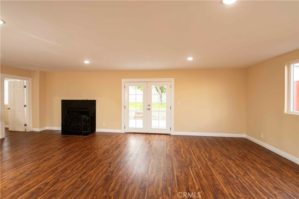 143 West 234th Place Carson, CA 90745 - Photo 18 of 46 a view of an empty room with wooden floor and a window