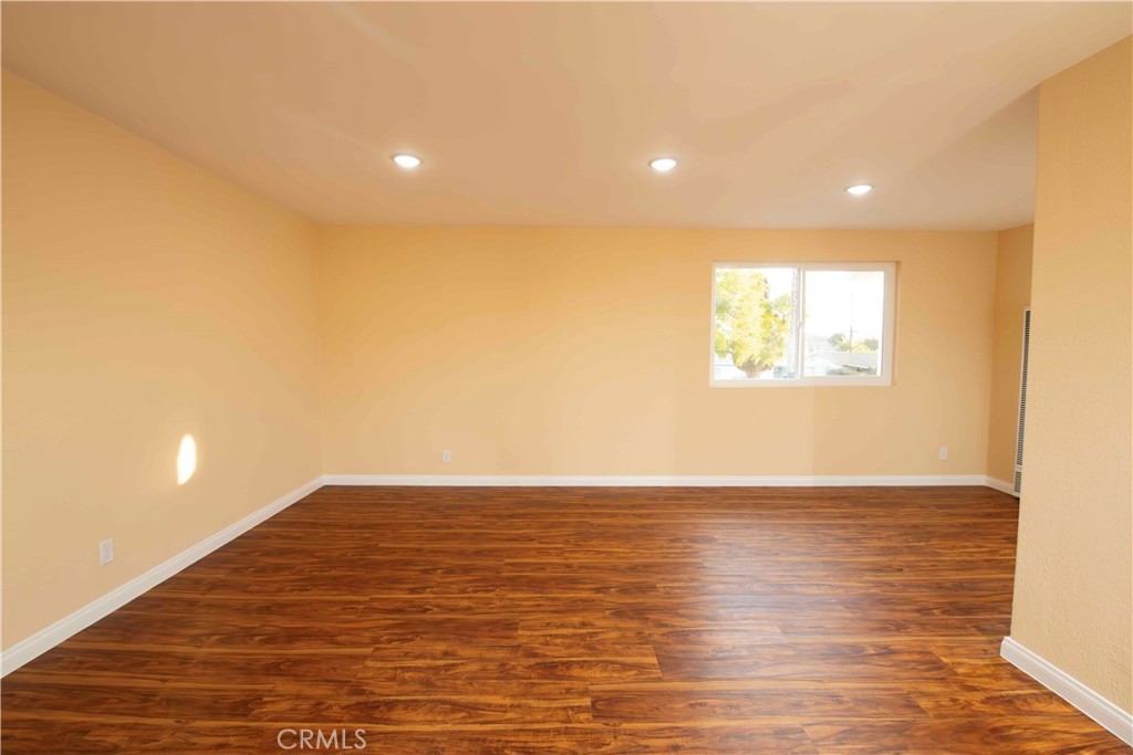 143 West 234th Place Carson, CA 90745 - Photo 36 of 46 a view of an empty room with wooden floor and a window