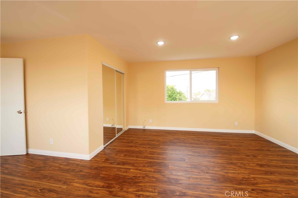 143 West 234th Place Carson, CA 90745 - Photo 37 of 46 a view of an empty room with wooden floor and a window