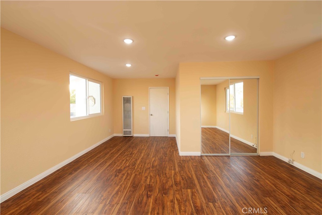 143 West 234th Place Carson, CA 90745 - Photo 38 of 46 a view of empty room with wooden floor and fan