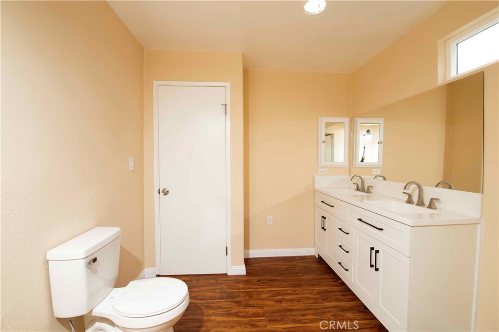 143 West 234th Place Carson, CA 90745 - Photo 40 of 46 a bathroom with a double vanity sink toilet and mirror