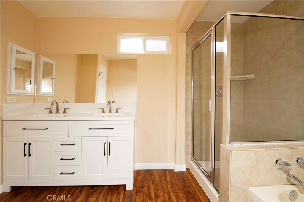 143 West 234th Place Carson, CA 90745 - Photo 42 of 46 a bathroom with a sink mirror and a shower
