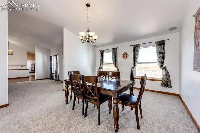 a view of a dining room with furniture and window