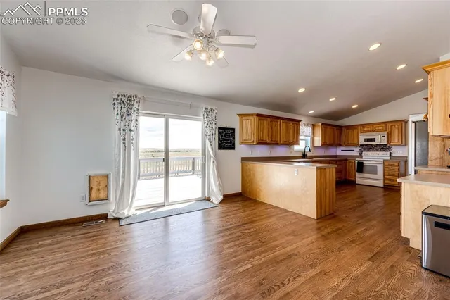 a view of kitchen with cabinets and wooden floor